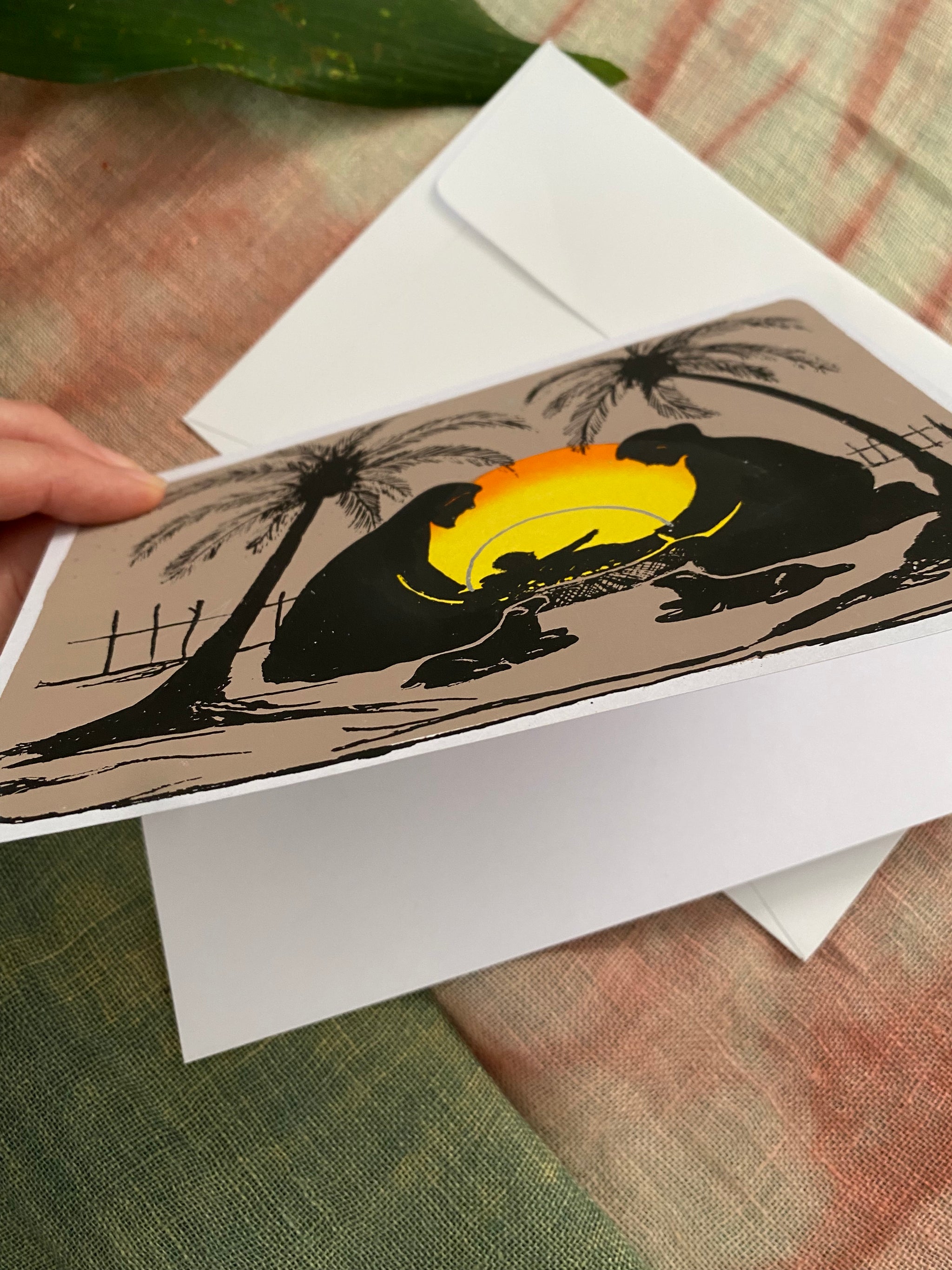 Greeting card with a sunset design on a white envelope