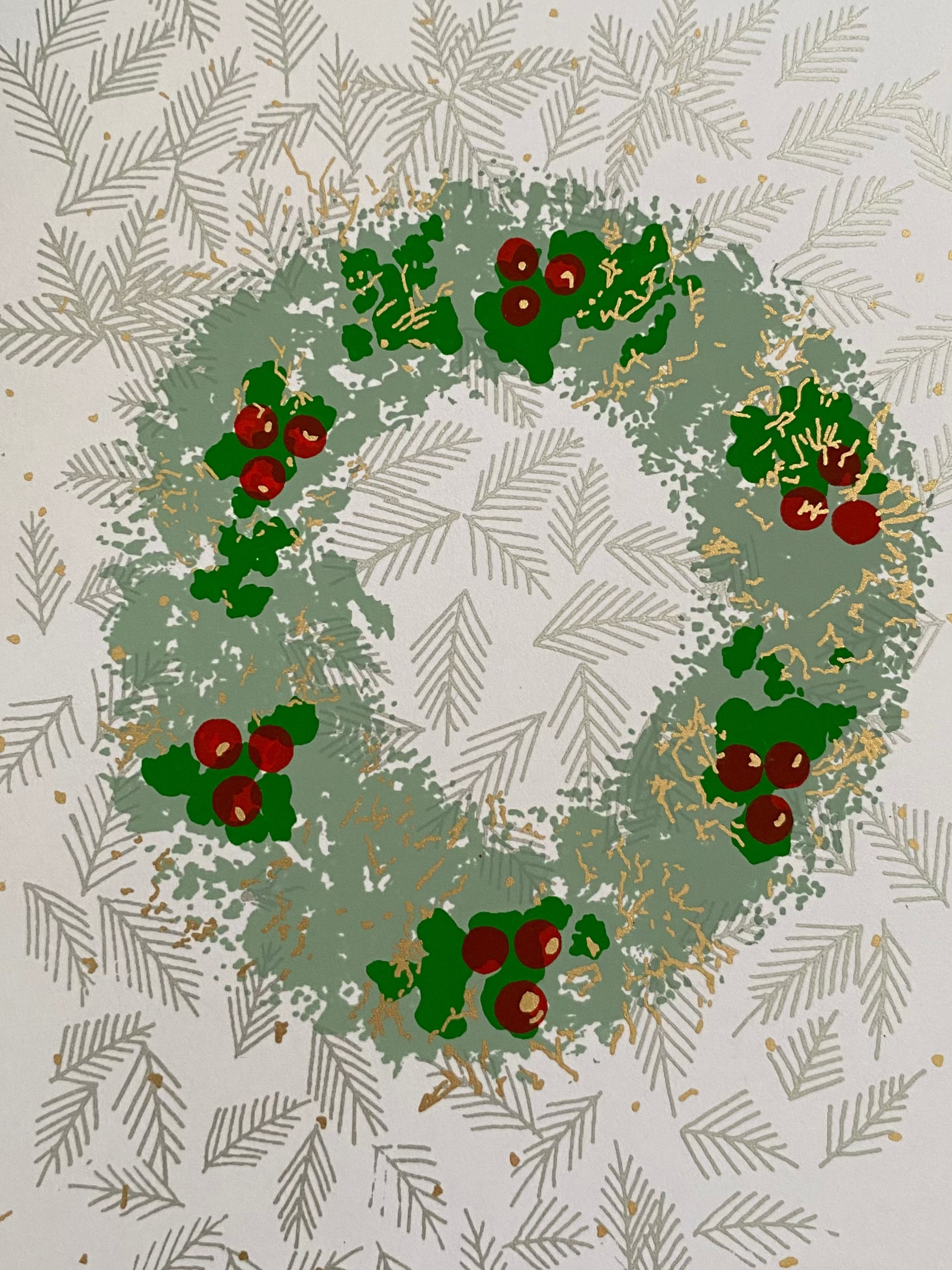 Card with a Christmas wreath design on a textured surface