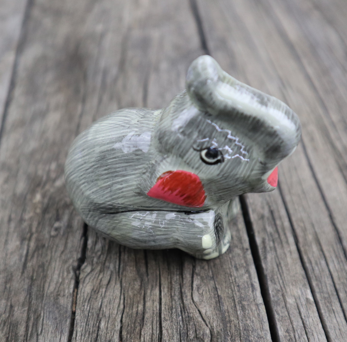 Fair Trade Ethical Sitting Elephant Picture of grey elephant with trunk facing upwards
