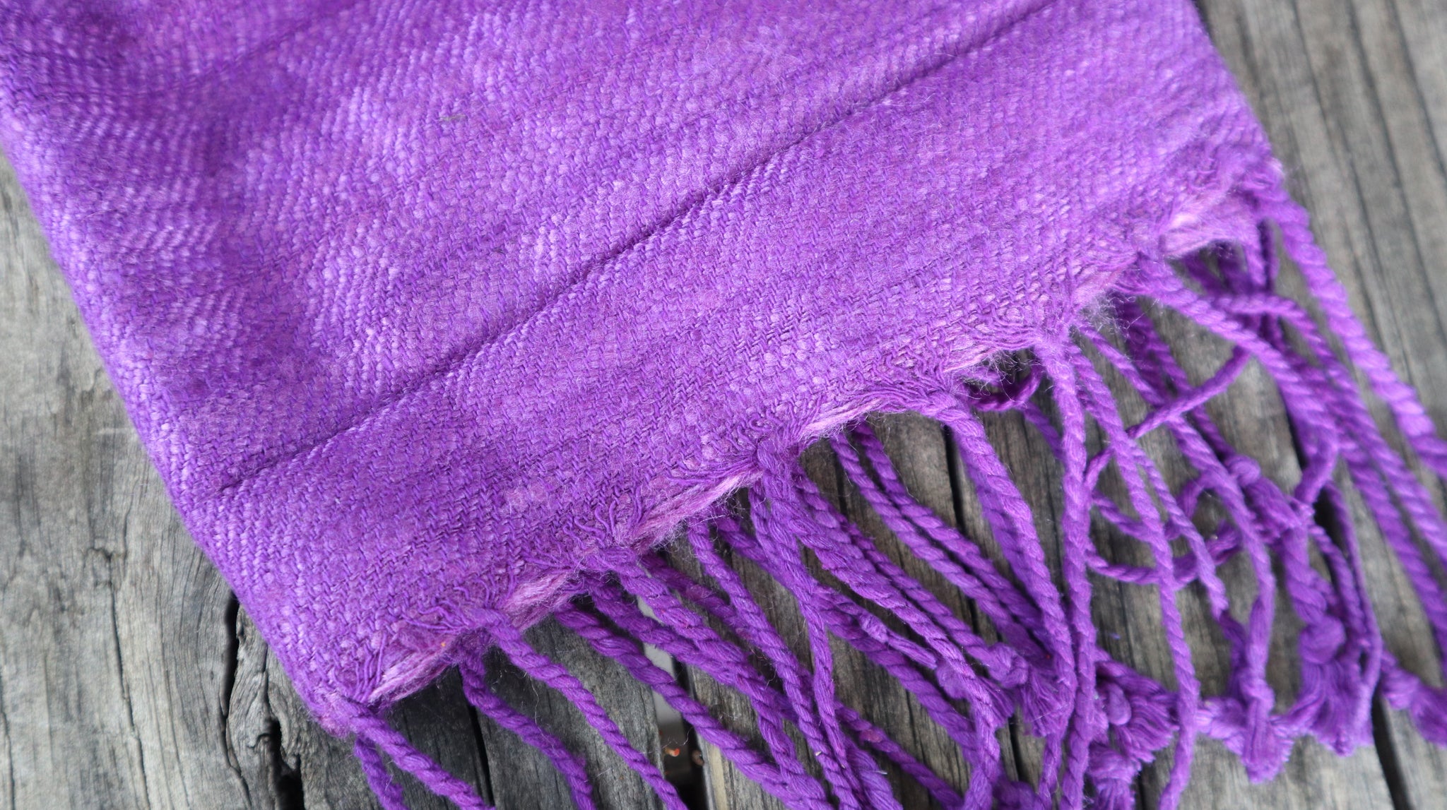 Detail of the tassels of the purple scarf
