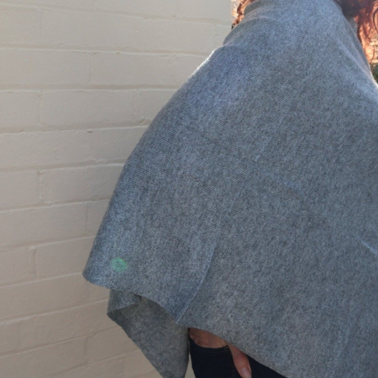 V neck cashmere poncho in grey colour. The poncho itself is in a v shape