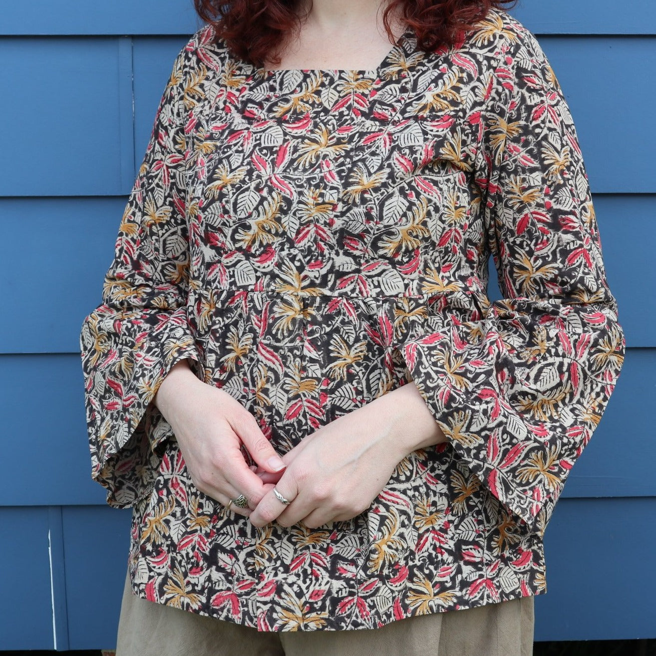 Fair trade ethical bell sleeve top with square neck, ebony patterned design with traditional Indian Tanjore Art - women, leaves and flowers are displayed