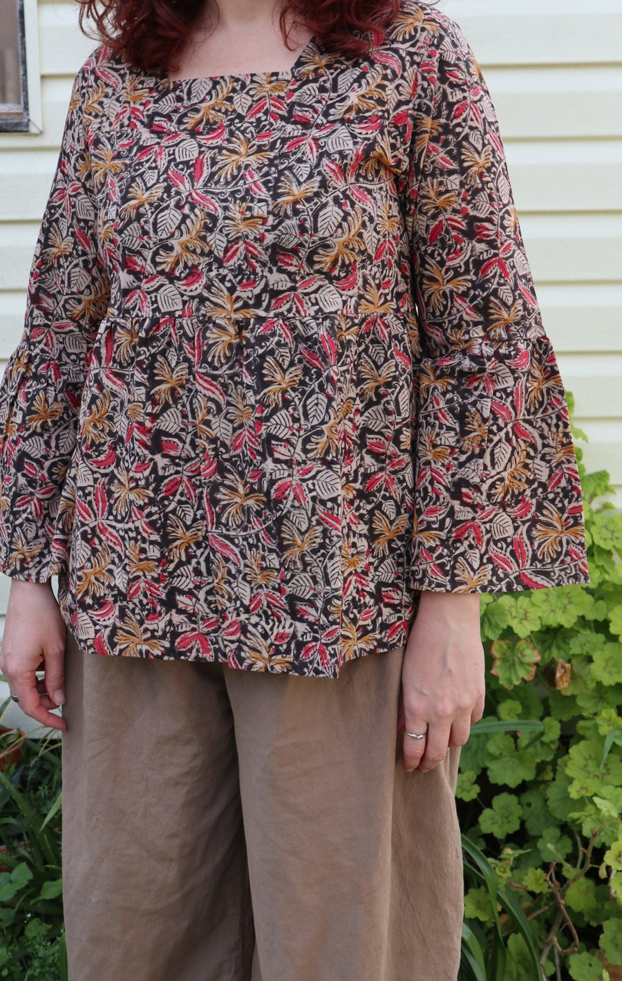 Fair trade ethical bell sleeve top with square neck, ebony patterned design with traditional Indian Tanjore Art - women, leaves and flowers are displayed