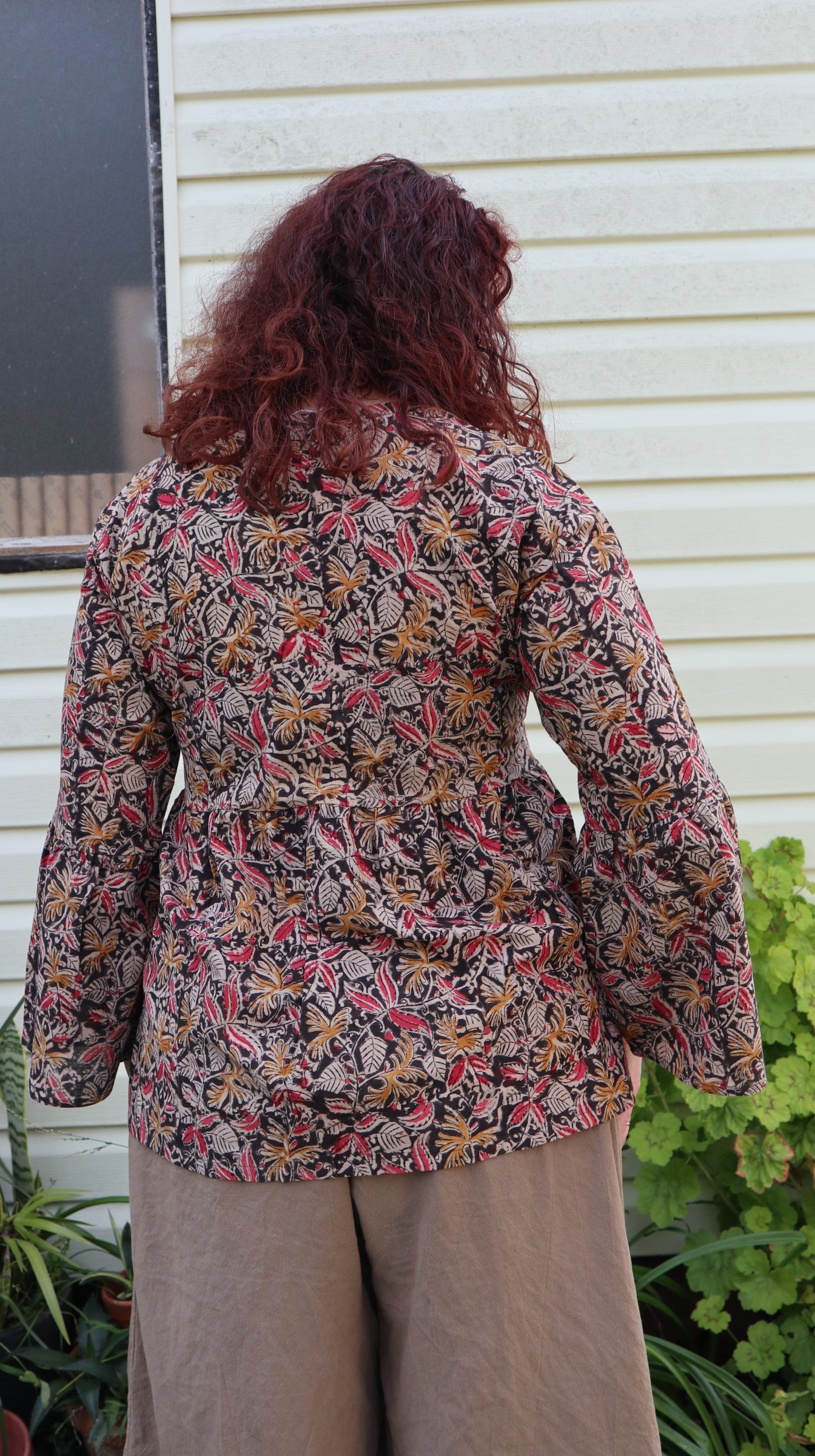 Fair trade ethical bell sleeve top with square neck, ebony patterned design with traditional Indian Tanjore Art - women, leaves and flowers are displayed