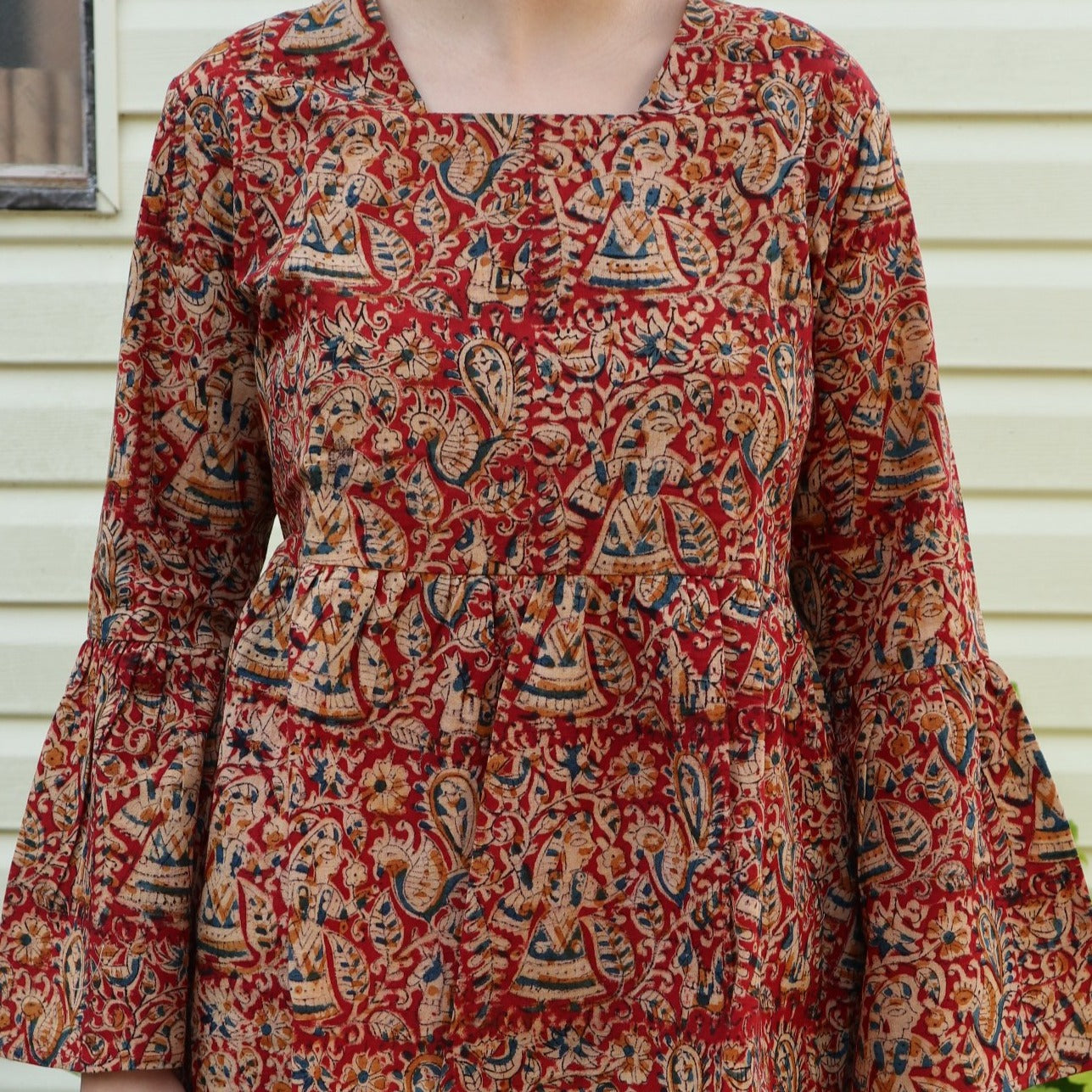 Fair trade ethical bell sleeve top with square neck. Red patterned design with traditional Indian Tanjore Art - women, birds, leaves and flowers are displayed