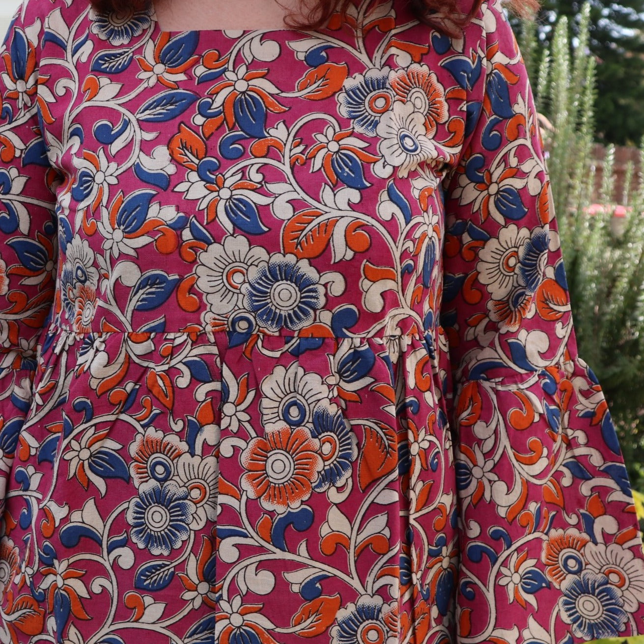 Fair trade ethical bell sleeve top with square neck, an orchid purple patterned design with traditional Indian Tanjore Art - vines with various flowers of blue and orange colours are displayed