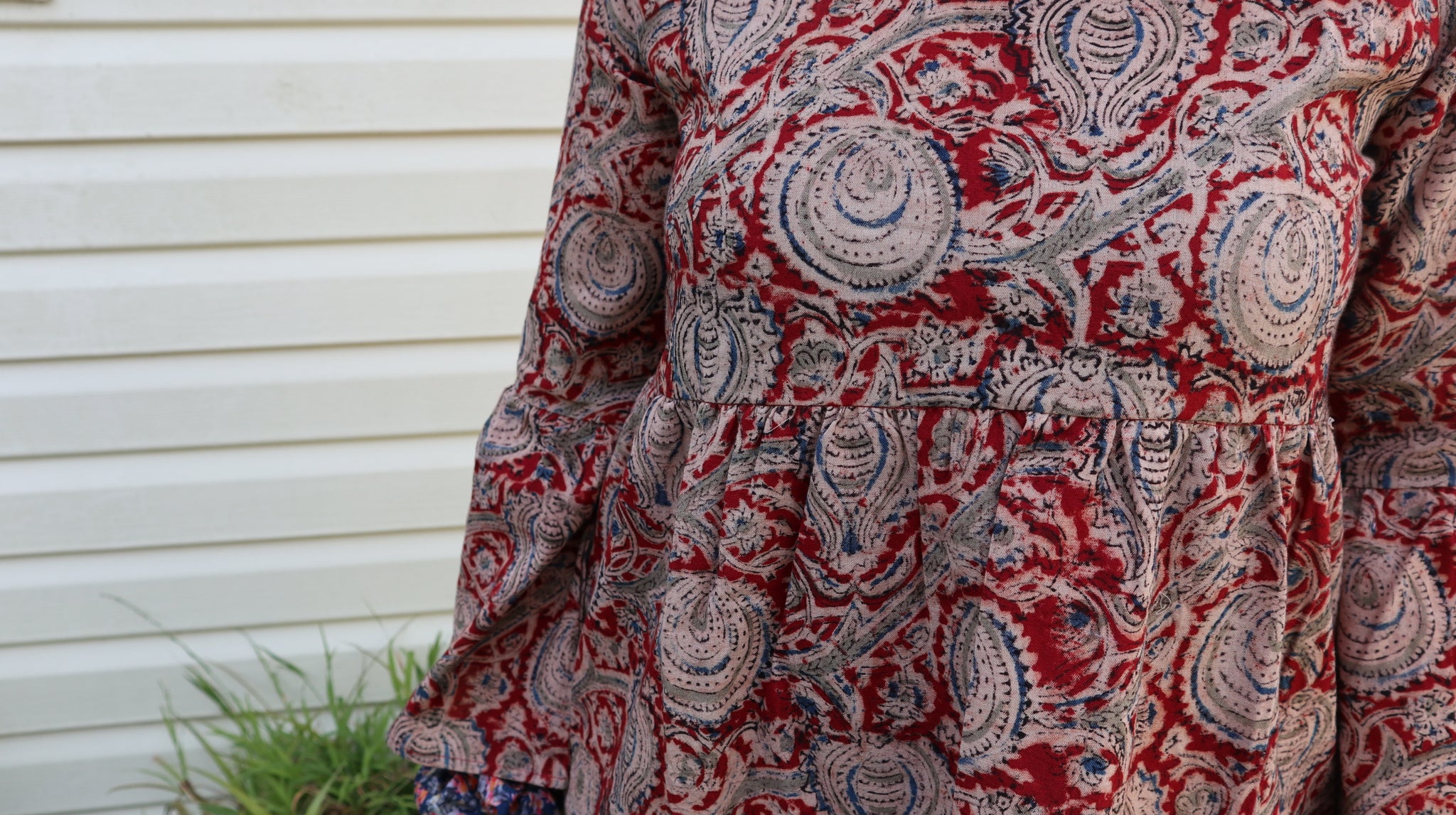 Fair trade ethical bell sleeve top with square neck, Red patterned design with traditional Indian Tanjore Art - branches with abstract fruit and leaves are displayed