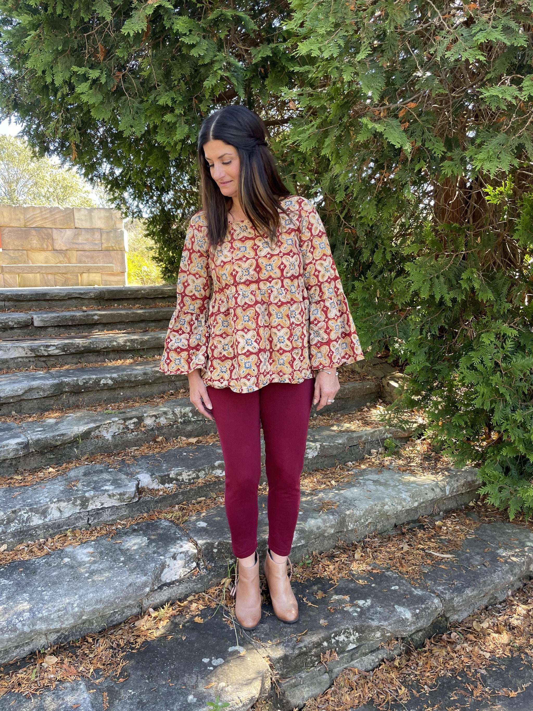Fair trade ethical bell sleeve top with square neck, a maroon coloured patterned design with traditional Indian Tanjore Art - large flowers of yellow and creme decorate the fabric