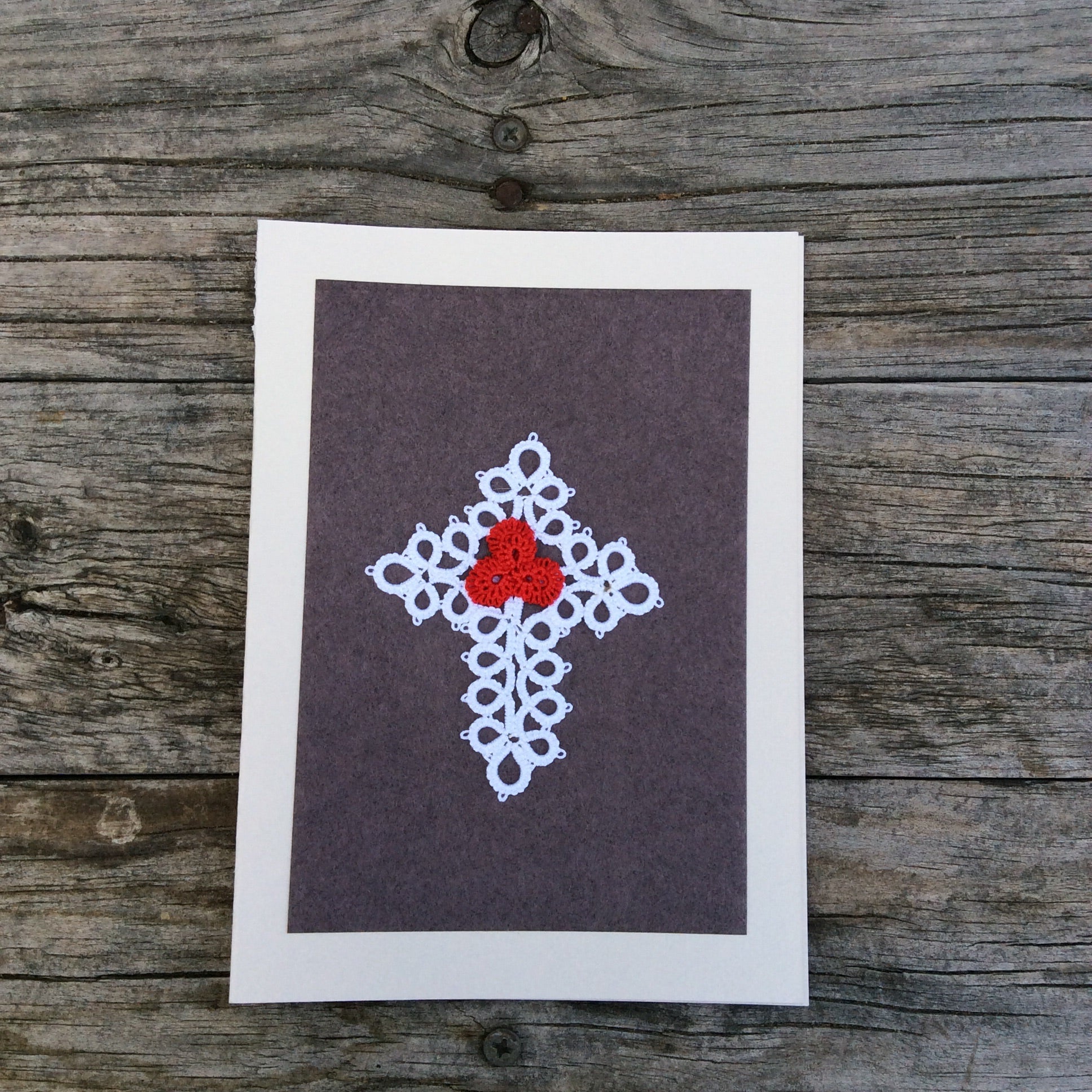 Black handmade card with a white boarder and a white and red tatted Cross in the middle.