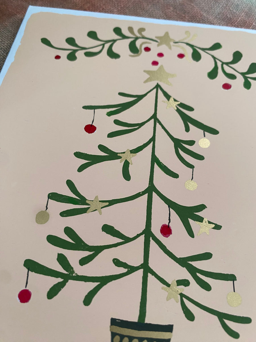 Greeting card with a Christmas tree design on a textured fabric background