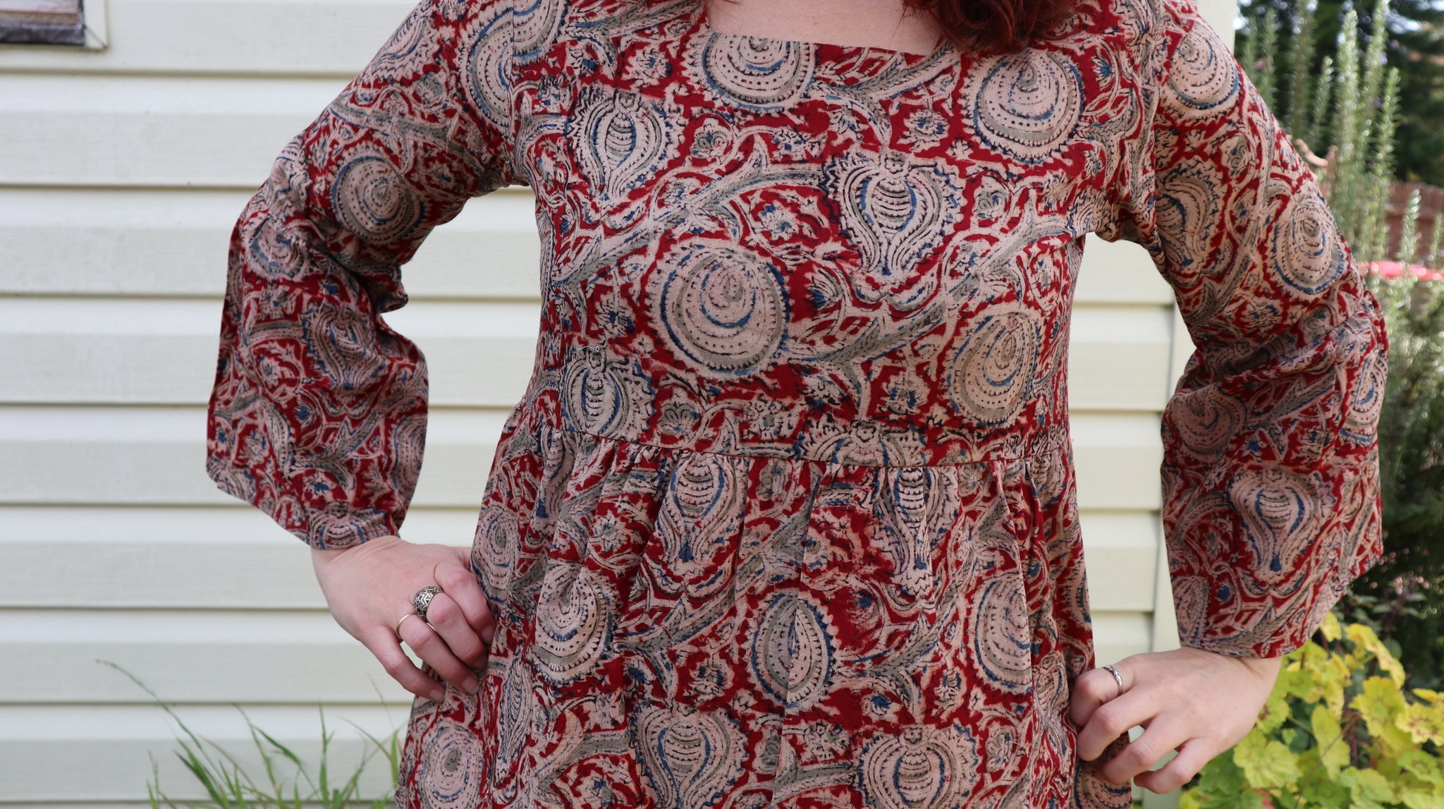 Fair trade ethical bell sleeve top with square neck, Red patterned design with traditional Indian Tanjore Art - branches with abstract fruit and leaves are displayed